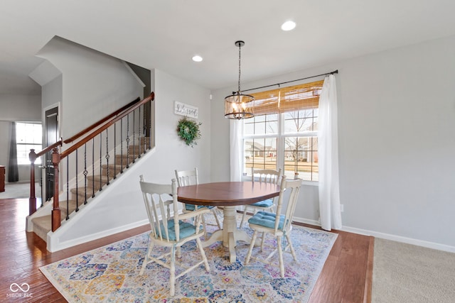 dining room with wood finished floors, baseboards, recessed lighting, stairs, and a chandelier