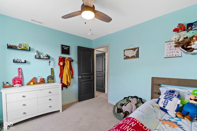 bedroom with baseboards, a ceiling fan, visible vents, and light carpet