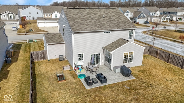 rear view of property featuring cooling unit, a yard, a fenced backyard, a shingled roof, and a residential view