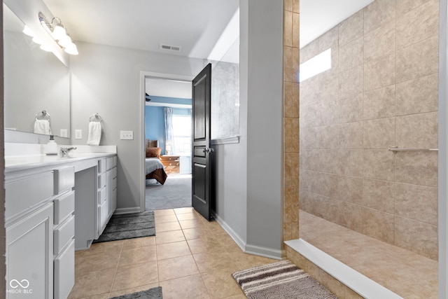 ensuite bathroom with vanity, visible vents, ensuite bathroom, walk in shower, and tile patterned floors