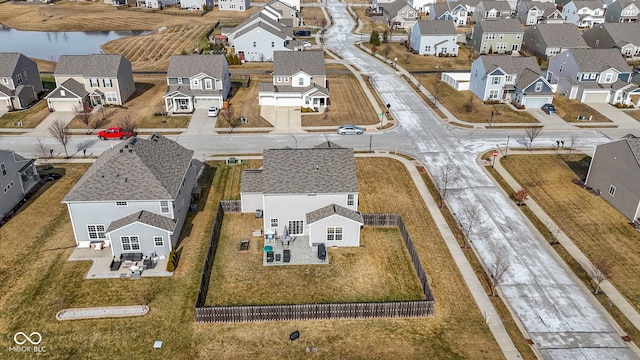 drone / aerial view featuring a residential view and a water view