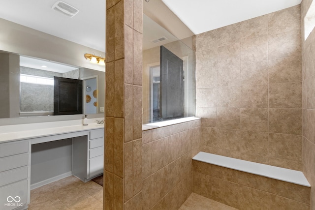 full bath featuring tile patterned floors, visible vents, vanity, and a walk in shower