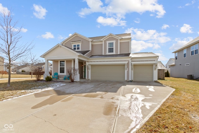 view of front of home featuring an attached garage, cooling unit, concrete driveway, and a front lawn