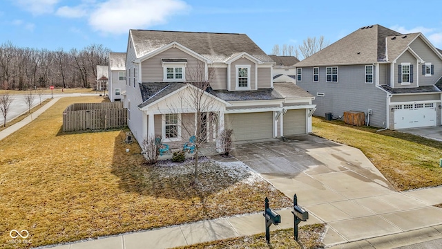 traditional-style home featuring a shingled roof, a front lawn, fence, concrete driveway, and an attached garage