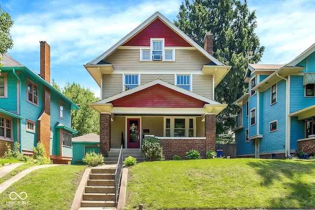 4029 Broadway St, Indianapolis, IN 46205 - traditional style home featuring covered porch, a front yard, a chimney, and brick siding