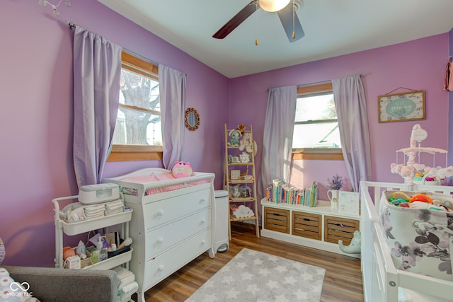 bedroom featuring multiple windows, ceiling fan, and light wood-type flooring