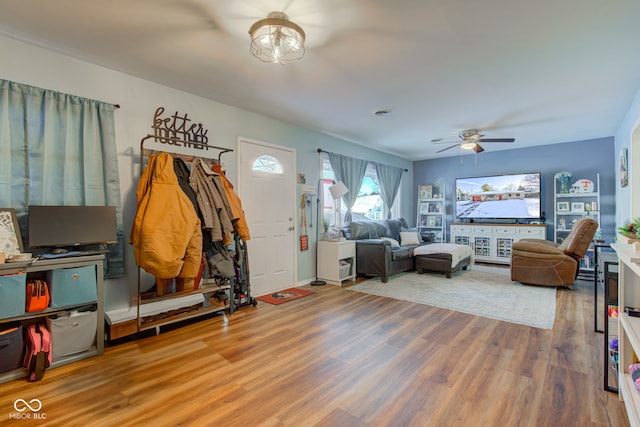 living room featuring hardwood / wood-style flooring and ceiling fan