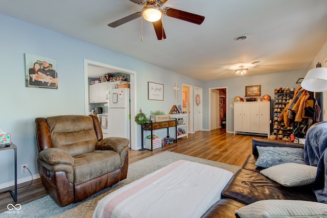 living room featuring ceiling fan and wood-type flooring