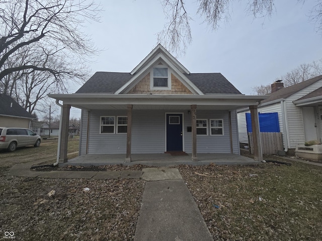 view of front of property with covered porch and roof with shingles