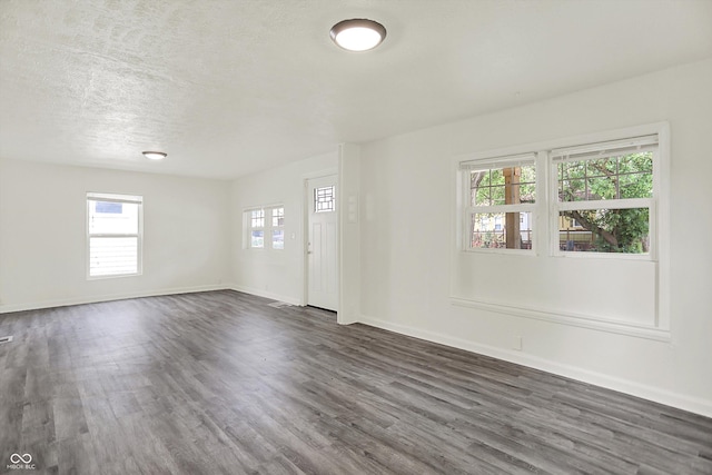 952 N Concord St, Indianapolis, IN 46222 - unfurnished room featuring dark wood-style floors, plenty of natural light, and a textured ceiling