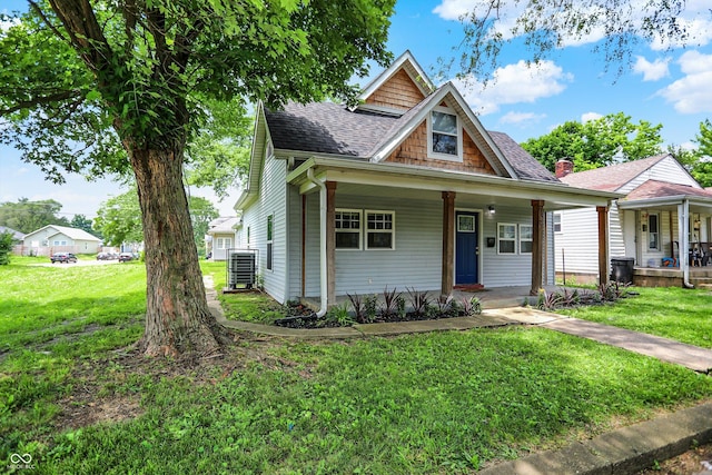 952 N Concord St, Indianapolis, IN 46222 - view of front facade featuring a porch, a front lawn, and a shingled roof