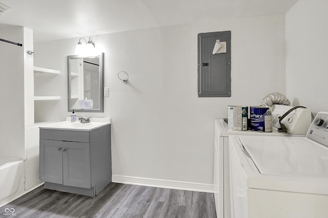 952 N Concord St, Indianapolis, IN 46222 - full bathroom featuring electric panel, wood finished floors, vanity, and independent washer and dryer