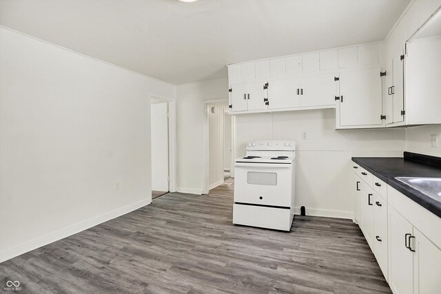 952 N Concord St, Indianapolis, IN 46222 - kitchen with white electric range, dark countertops, white cabinetry, and wood finished floors