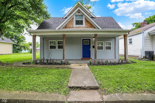 952 N Concord St, Indianapolis, IN 46222 - bungalow with a front lawn, covered porch, and a shingled roof