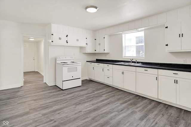 952 N Concord St, Indianapolis, IN 46222 - kitchen with white range with electric stovetop, light wood-type flooring, white cabinetry, and dark countertops