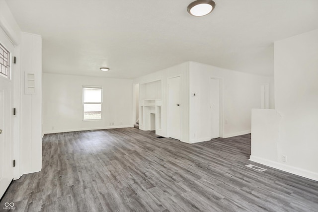 952 N Concord St, Indianapolis, IN 46222 - unfurnished living room featuring wood finished floors and baseboards
