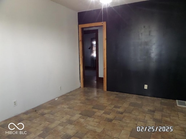 empty room with stone finish floor and visible vents