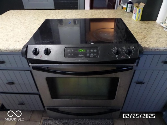 details with light countertops and stainless steel range with electric stovetop