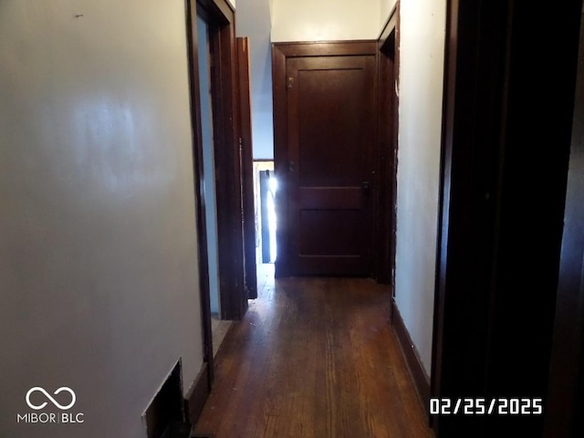 hallway with dark wood-type flooring