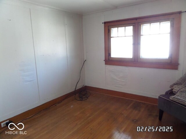 unfurnished room with dark wood-type flooring and baseboards