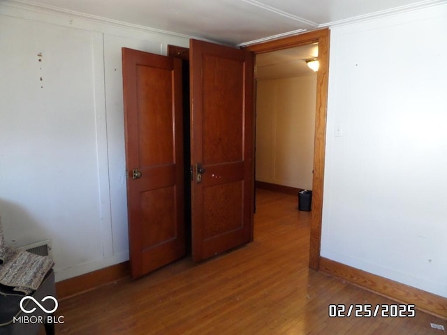 interior space with wood finished floors and baseboards