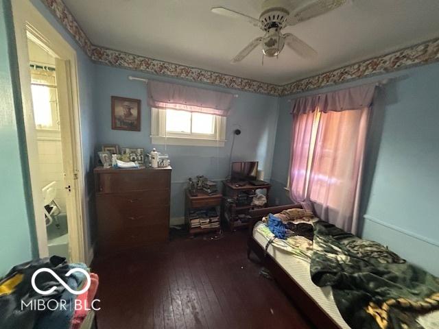 bedroom featuring dark hardwood / wood-style flooring and ceiling fan