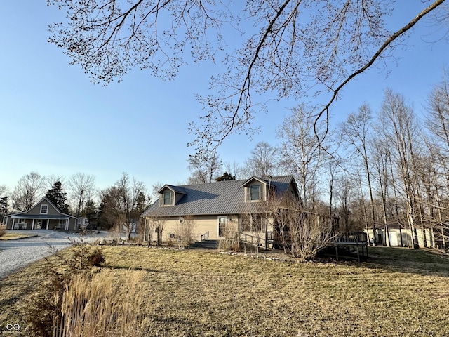 view of home's exterior featuring a lawn and metal roof