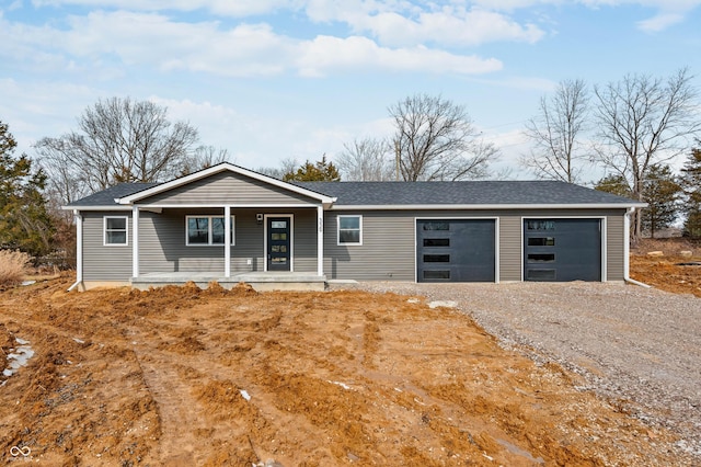 single story home featuring driveway, a porch, roof with shingles, and an attached garage