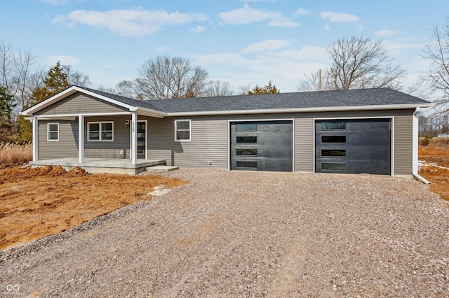 ranch-style house featuring driveway, a porch, roof with shingles, and an attached garage