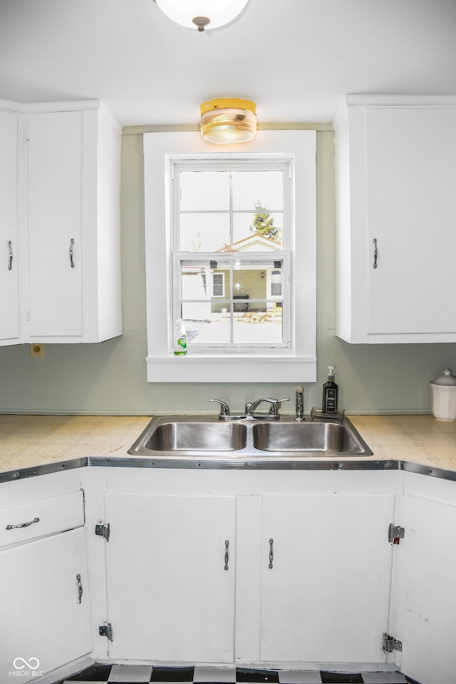 kitchen with white cabinetry and sink