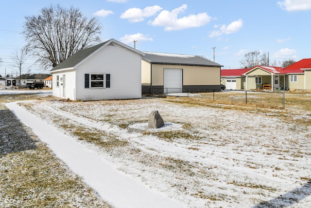 view of front of property with a garage and an outbuilding