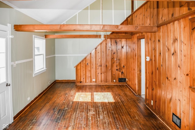 bonus room with vaulted ceiling and dark wood-type flooring