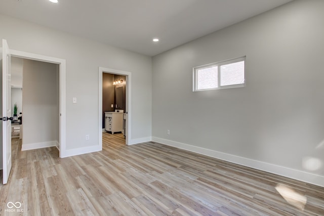 unfurnished room featuring light wood finished floors, baseboards, and recessed lighting