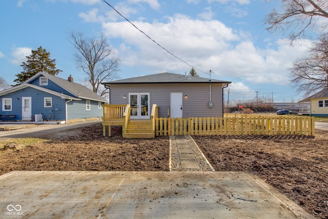 bungalow featuring french doors and fence