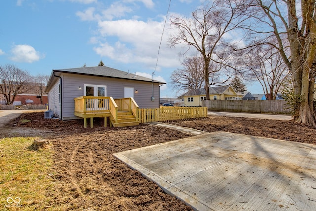 rear view of property featuring a patio, cooling unit, fence, and a wooden deck