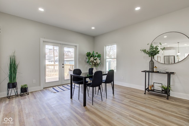 dining room featuring french doors, light wood-type flooring, and recessed lighting