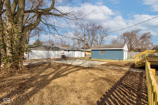 view of yard featuring fence and an outdoor structure