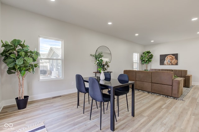 dining space with light wood-type flooring, visible vents, and recessed lighting