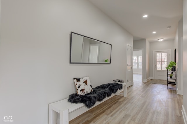 interior space with light wood finished floors, baseboards, and recessed lighting