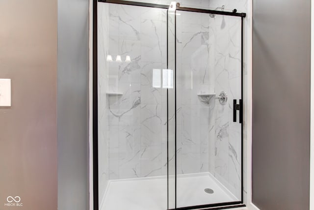 full bath featuring a marble finish shower