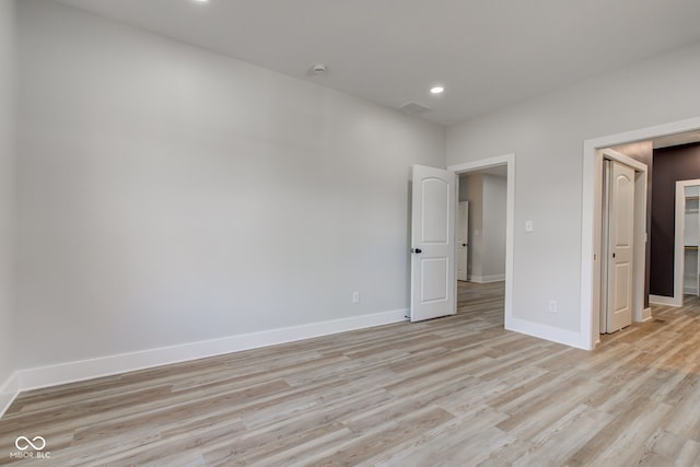 unfurnished bedroom featuring light wood-type flooring, visible vents, baseboards, and recessed lighting