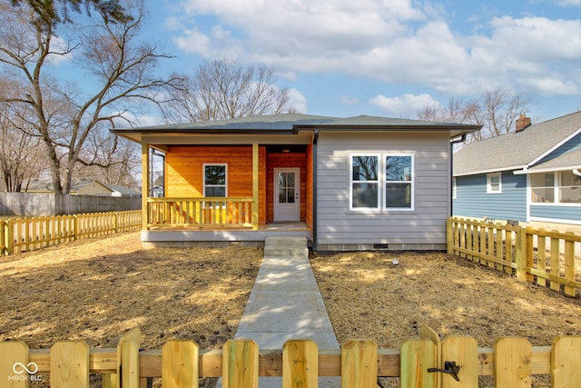 bungalow featuring crawl space, a fenced front yard, and a porch