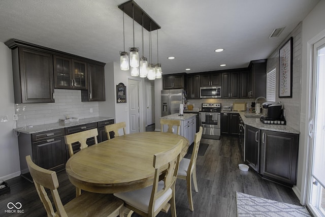 dining area with sink and dark hardwood / wood-style flooring