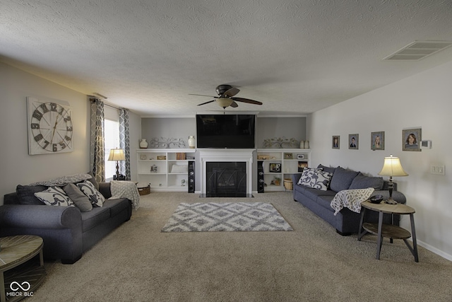 carpeted living room featuring a textured ceiling and ceiling fan