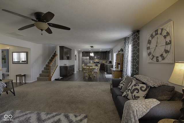 living room with dark hardwood / wood-style floors and a textured ceiling