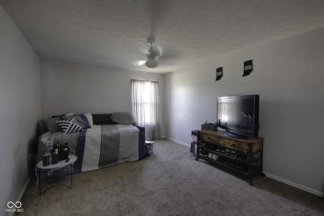 bedroom featuring ceiling fan, carpet, and a textured ceiling