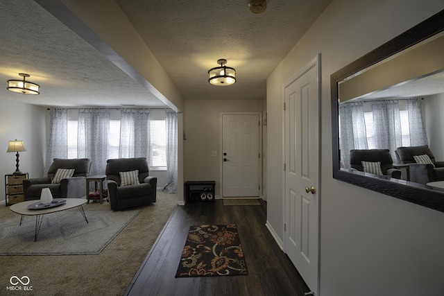 entrance foyer featuring a textured ceiling and dark hardwood / wood-style flooring