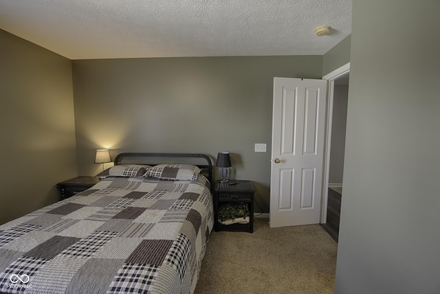 bedroom with light colored carpet and a textured ceiling