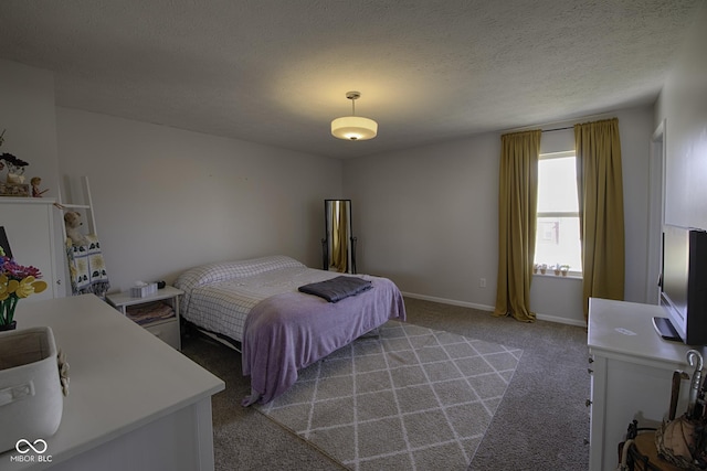 bedroom featuring light colored carpet and a textured ceiling