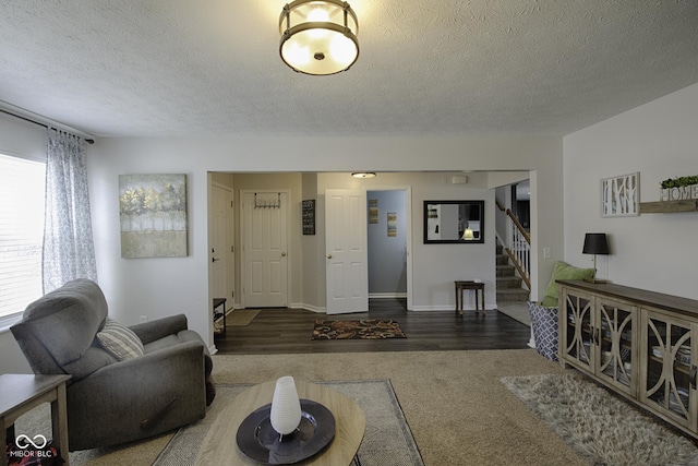 carpeted living room with a textured ceiling